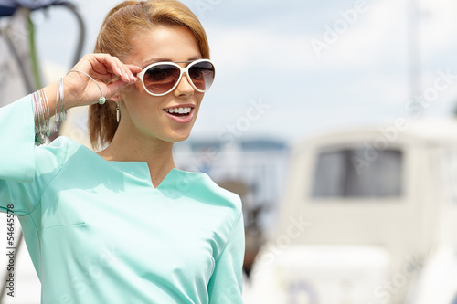 Photo: Elegant retro woman wear dress , near the yacht marine. 60's in Elegant retro woman wear dress , near the yacht marine. 60's in