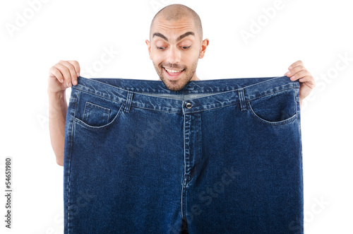 Photo: Man in dieting concept with oversized jeans Man in dieting concept with oversized jeans