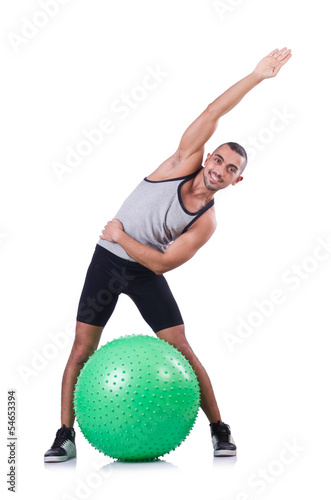 Photo: Man with swiss ball doing exercises on white Man with swiss ball doing exercises on white