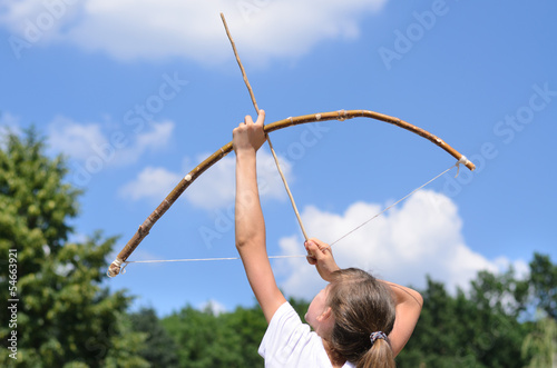 Photo: Young girl practising archery Young girl practising archery