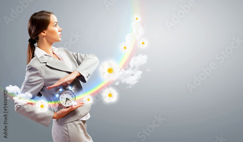 Photo: Businesswoman holding alarmclock Businesswoman holding alarmclock
