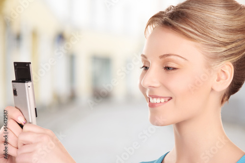 Photo: woman taking picture with phone in city woman taking picture with phone in city