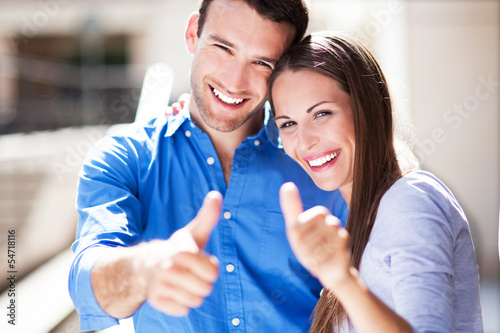 Photo: Smiling couple with thumbs up Smiling couple with thumbs up