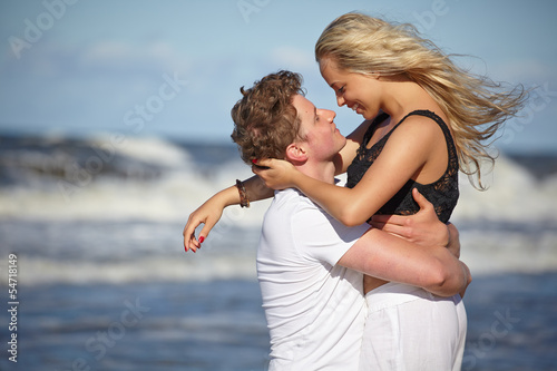 Photo: Close up portrait of romantic kiss on beach. Close up portrait of romantic kiss on beach.