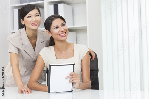 Photo: Asian Chinese & Hispanic Businesswomen Using Tablet Computer Asian Chinese & Hispanic Businesswomen Using Tablet Computer