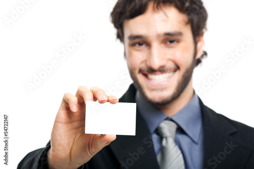 Photo: Smiling businessman showing a blank card Smiling businessman showing a blank card