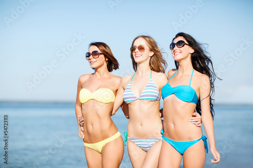 Photo: girls in bikini walking on the beach girls in bikini walking on the beach