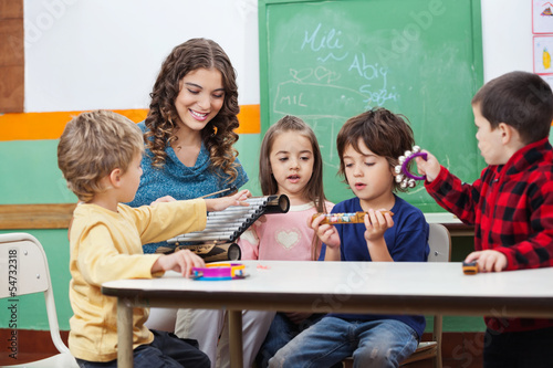 Photo: Children And Teacher Playing With Musical Instruments Children And Teacher Playing With Musical Instruments