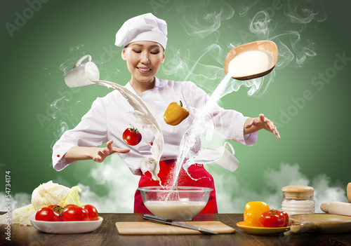 Photo: Asian female cooking with magic Asian female cooking with magic