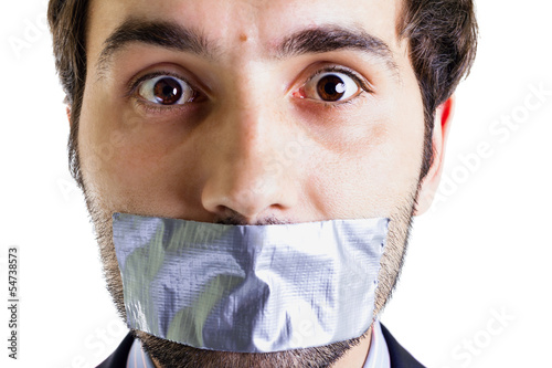 Photo: Scared businessman with duct tape on mouth Scared businessman with duct tape on mouth