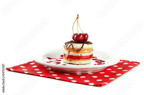 Photo: Tasty biscuit cake on plate isolated on white Tasty biscuit cake on plate isolated on white