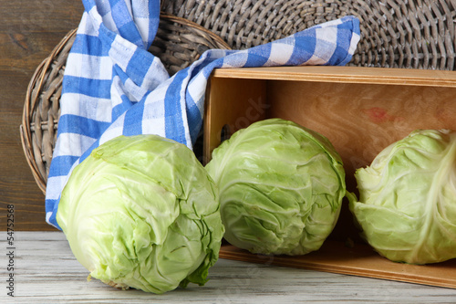 Photo: Cabbage on table on wooden background Cabbage on table on wooden background