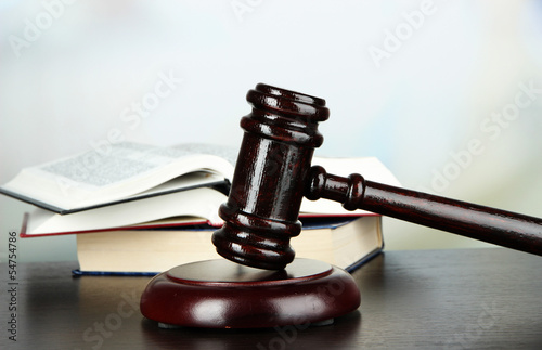 Photo: Gavel and books on table on light background Gavel and books on table on light background