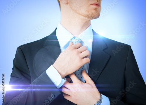 Photo: man adjusting his tie man adjusting his tie