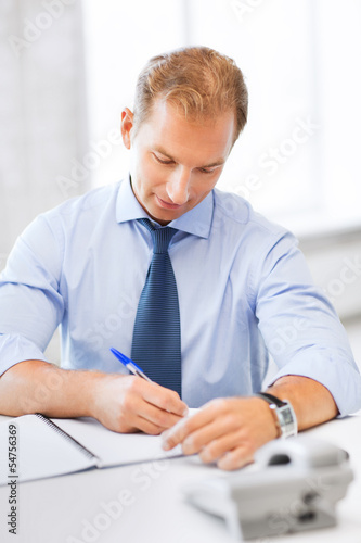 Photo: handsome businessman working in the office handsome businessman working in the office