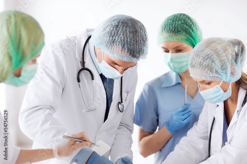 Photo: young group of doctors doing operation young group of doctors doing operation