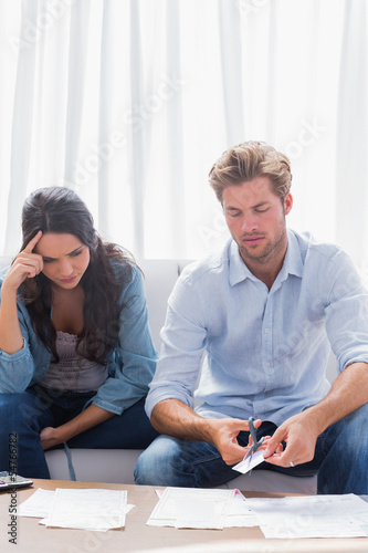 Photo: Worried couple doing their accounts together Worried couple doing their accounts together