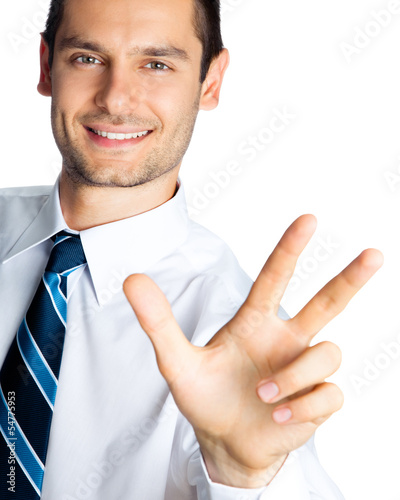 Photo: Businessman showing three fingers, isolated Businessman showing three fingers, isolated