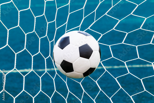 Photo: soccer ball in goal net soccer ball in goal net