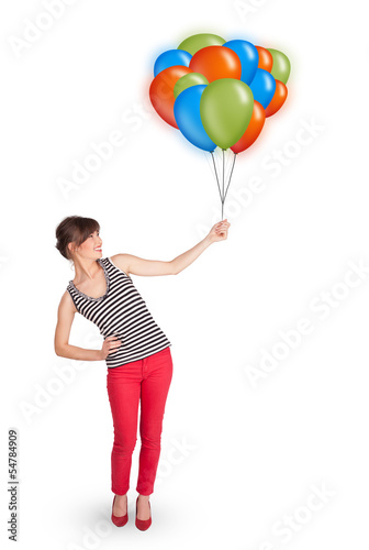 Photo: Young woman holding colorful balloons Young woman holding colorful balloons