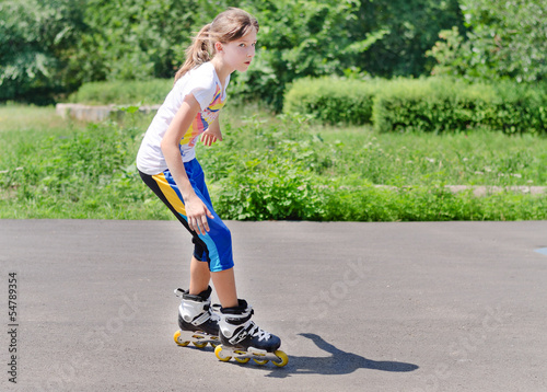 Photo: Young teenage girl rollerblading Young teenage girl rollerblading