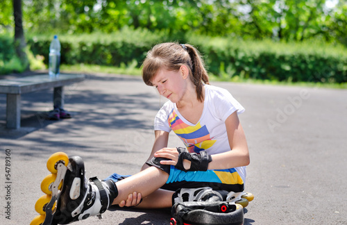 Photo: Skater nursing an injured knee Skater nursing an injured knee
