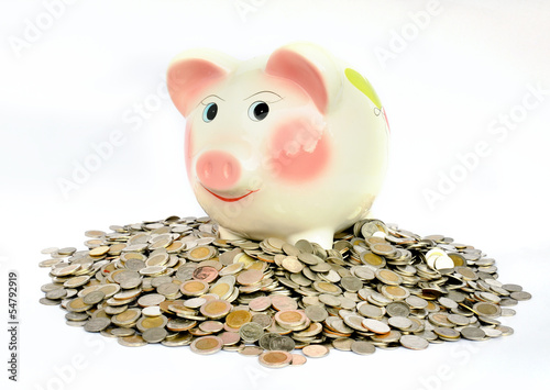 Photo: Pink piggy bank with many coins Pink piggy bank with many coins