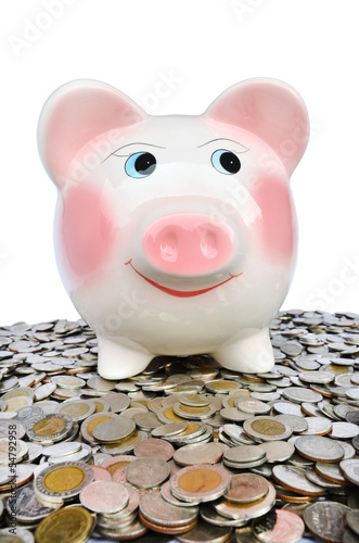 Photo: Pink piggy bank with many coins Pink piggy bank with many coins