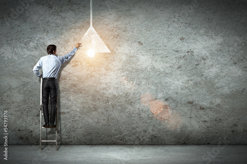 Photo: Business man drawing lamp Business man drawing lamp