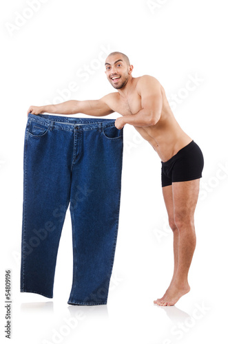 Photo: Man in dieting concept with oversized jeans Man in dieting concept with oversized jeans
