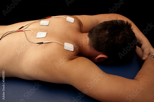 Photo: Man with TENS on his back Man with TENS on his back