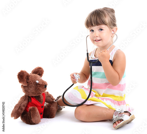 Photo: Little cute girl playing doctor, isolated on white Little cute girl playing doctor, isolated on white