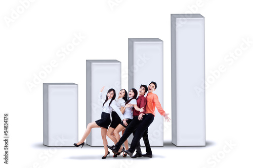 Photo: Happy business team and diagram Happy business team and diagram