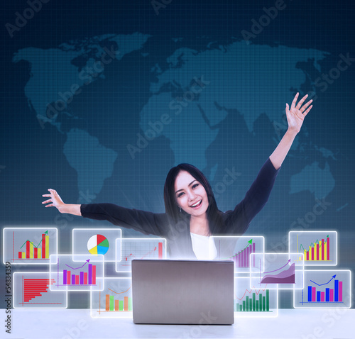 Photo: Happy businesswoman with bar graphs Happy businesswoman with bar graphs