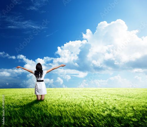 Photo: happy young woman in white dress standing in field happy young woman in white dress standing in field