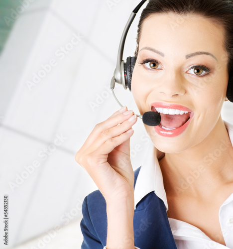 Photo: Beautiful young call-center assistant Beautiful young call-center assistant