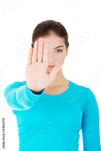 Photo: Hold on, Stop gesture showed by young woman Hold on, Stop gesture showed by young woman