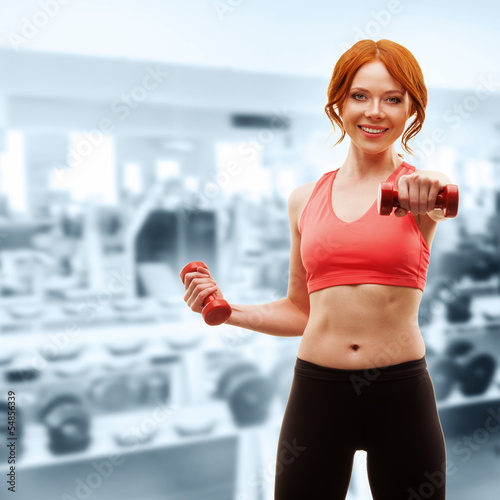 Photo: woman exercising with dumbbells woman exercising with dumbbells