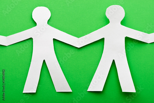 Photo: two paper human on green two paper human on green