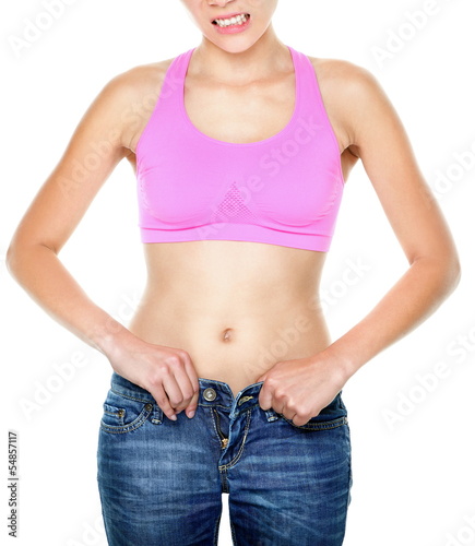 Photo: Weight gain and weight loss woman buttoning pants Weight gain and weight loss woman buttoning pants