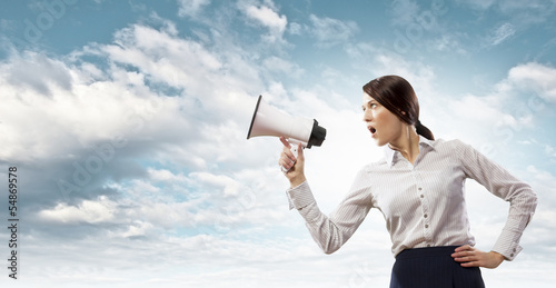 Photo: Businesswoman screaming in megaphone Businesswoman screaming in megaphone