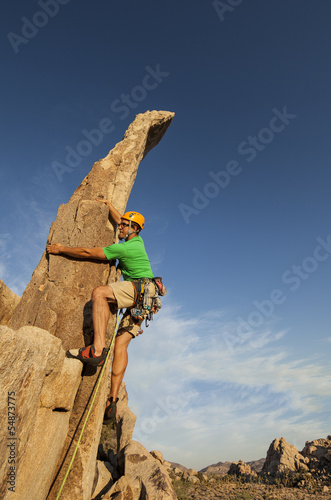 Photo: Successful climber at the top. Successful climber at the top.