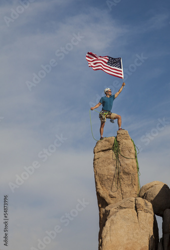 Photo: Successful climber at the top. Successful climber at the top.
