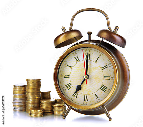 Photo: Antique clock and coins isolated on white Antique clock and coins isolated on white