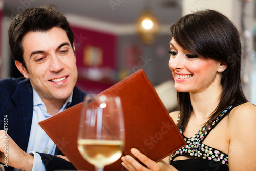 Photo: Couple reading a menu Couple reading a menu