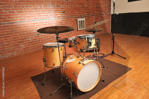 Photo: Set of drums in a brick and wood studio Set of drums in a brick and wood studio