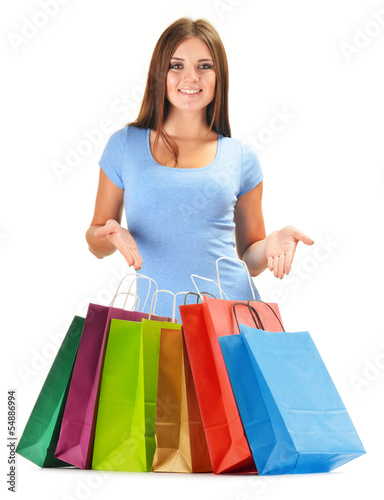 Photo: Young happy woman with colorful paper shopping bags isolated Young happy woman with colorful paper shopping bags isolated