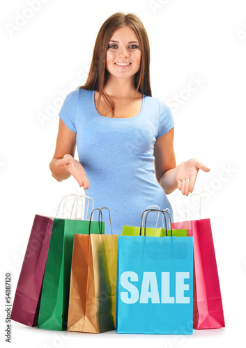 Photo: Young happy woman with colorful paper shopping bags isolated Young happy woman with colorful paper shopping bags isolated
