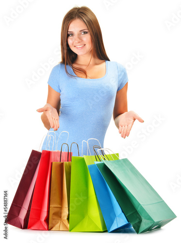 Photo: Young happy woman with colorful paper shopping bags isolated Young happy woman with colorful paper shopping bags isolated