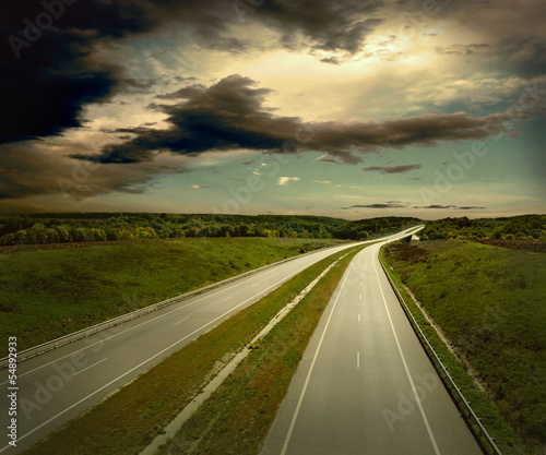 Photo: Beautiful view on the road under sky with clouds Beautiful view on the road under sky with clouds